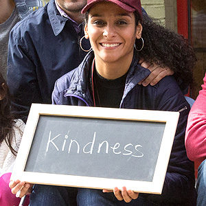 Health - Woman holding Kindness Sign